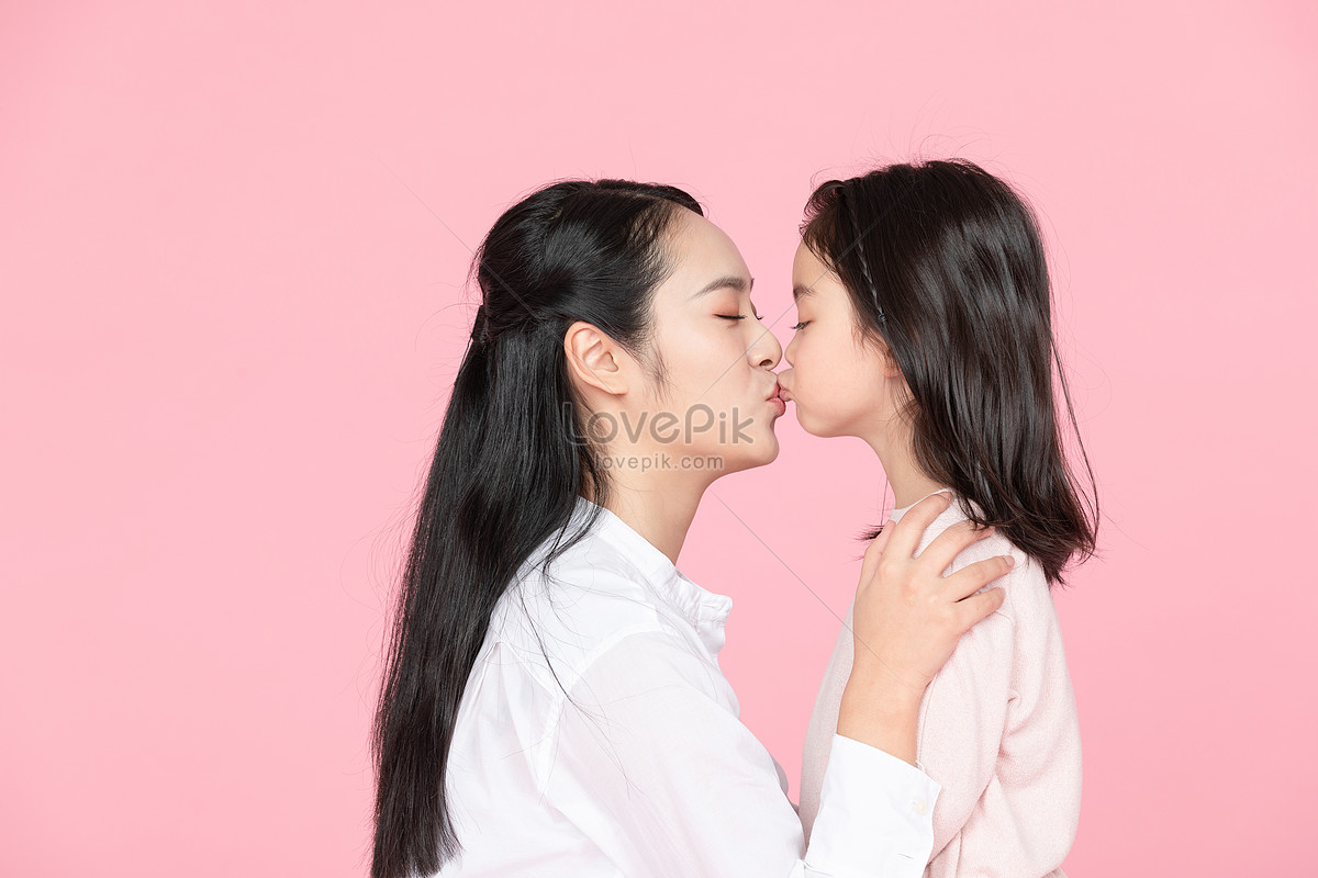intimate mother and daughter kissing
